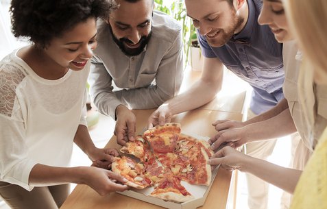group of friends eating pizza